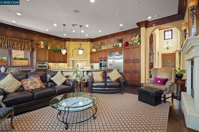 living room featuring sink, dark hardwood / wood-style floors, crown molding, and a towering ceiling