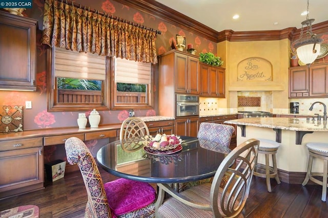 dining area featuring dark hardwood / wood-style floors, sink, and ornamental molding