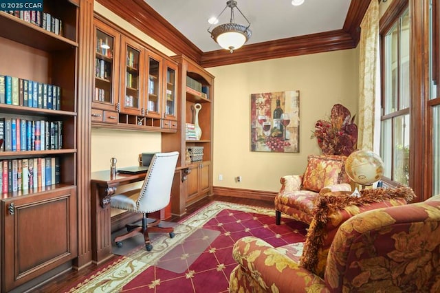 office area with built in desk, crown molding, and built in features