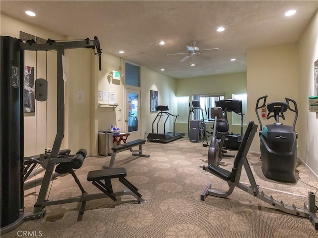 exercise room with light carpet and ceiling fan