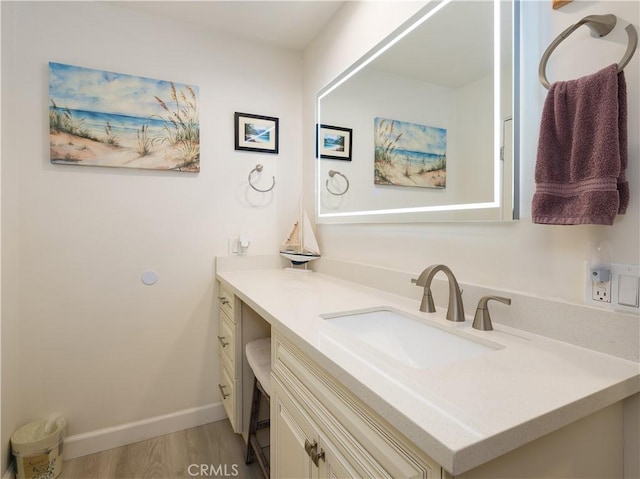 bathroom with hardwood / wood-style flooring and vanity