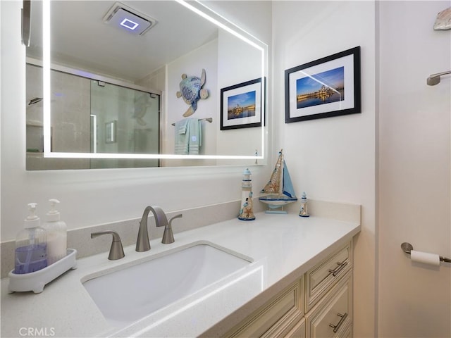 bathroom featuring an enclosed shower and vanity