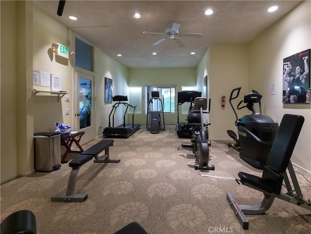 exercise area featuring ceiling fan and light colored carpet