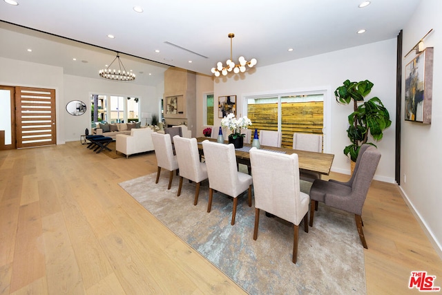 dining space featuring a notable chandelier and light hardwood / wood-style floors