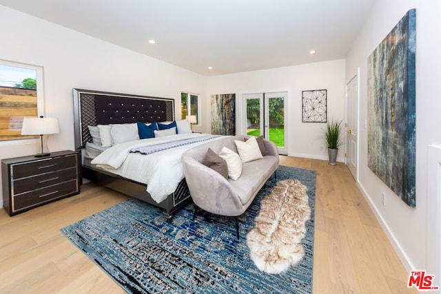 bedroom featuring light hardwood / wood-style floors and french doors