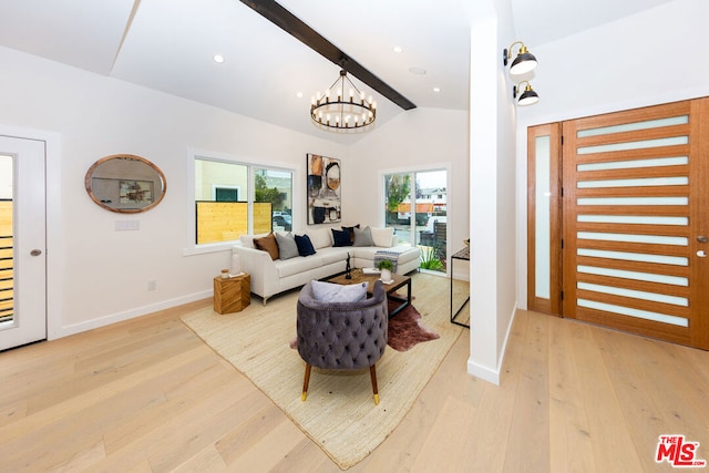 living room featuring an inviting chandelier, light hardwood / wood-style flooring, and vaulted ceiling with beams