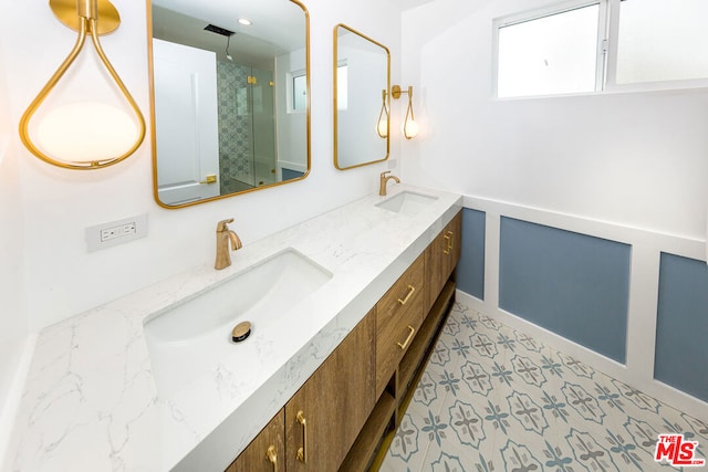 bathroom featuring walk in shower and vanity