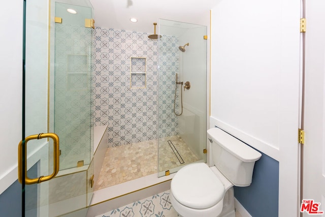 bathroom featuring an enclosed shower and toilet