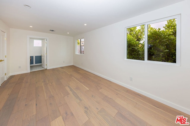 empty room with light hardwood / wood-style flooring