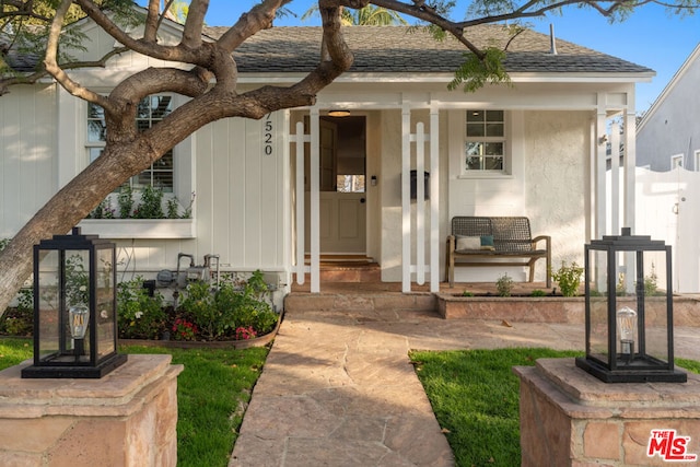 view of exterior entry featuring a porch