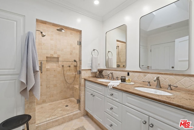 bathroom featuring crown molding, a shower with shower door, backsplash, and vanity