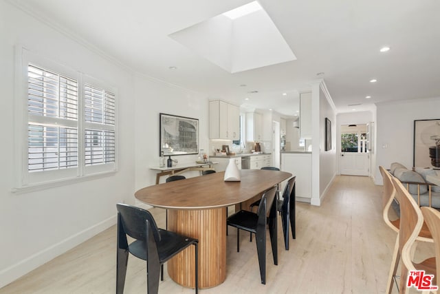 dining space with crown molding, a healthy amount of sunlight, and light hardwood / wood-style floors