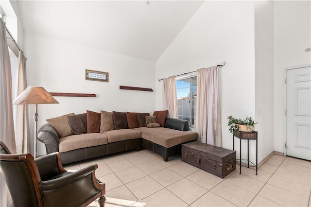 tiled living room featuring high vaulted ceiling