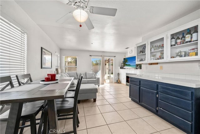 kitchen with ceiling fan, light tile patterned floors, blue cabinets, and white cabinetry