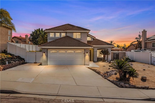 mediterranean / spanish home featuring a garage