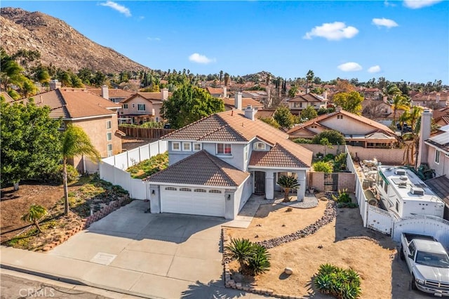 view of front of house featuring a garage and a mountain view