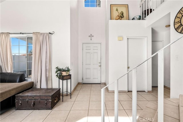 tiled entryway featuring a high ceiling