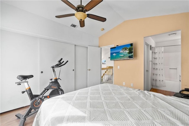 bedroom featuring lofted ceiling, ensuite bath, and ceiling fan