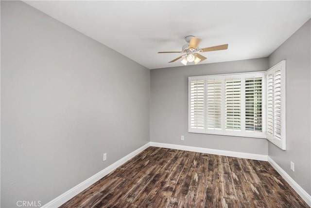 empty room with ceiling fan and dark wood-type flooring