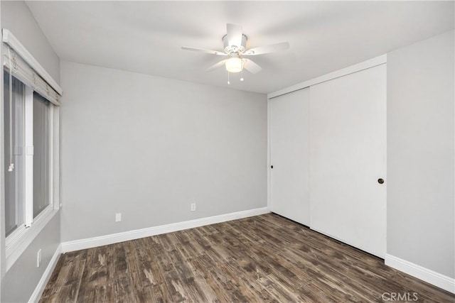 unfurnished bedroom with ceiling fan, a closet, and dark hardwood / wood-style flooring