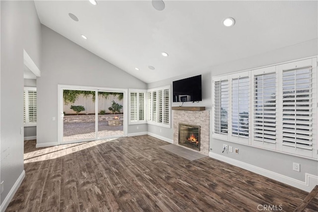 unfurnished living room featuring wood-type flooring and high vaulted ceiling