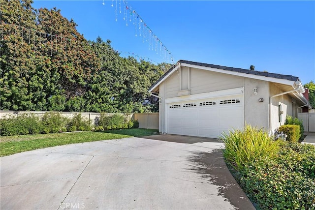 view of property exterior featuring an outdoor structure and a garage