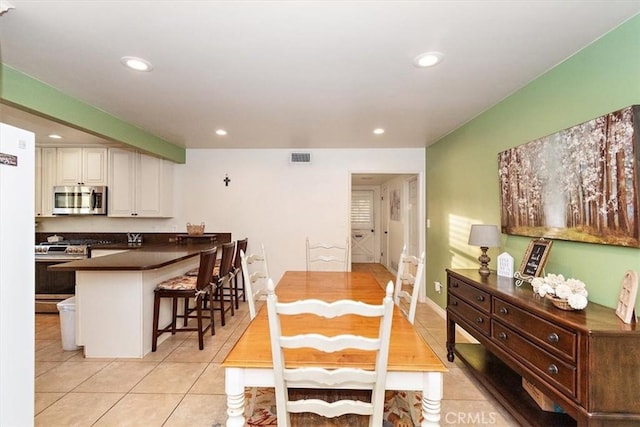 dining space featuring light tile patterned floors