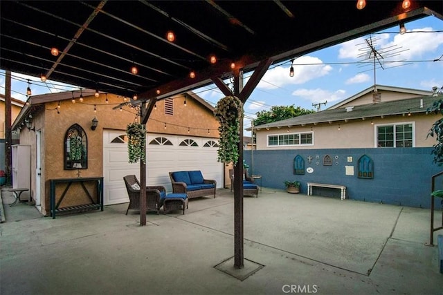 view of patio featuring a garage and an outbuilding