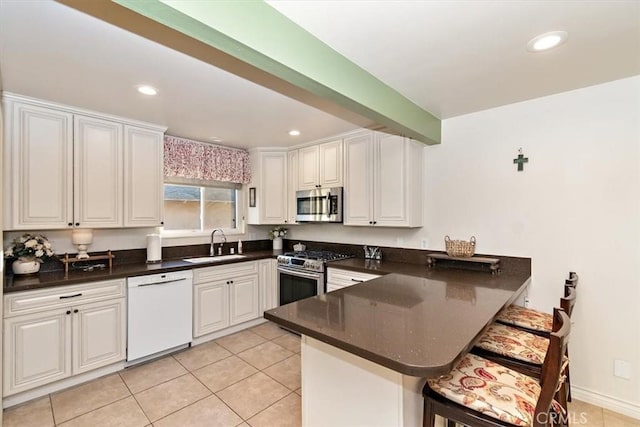 kitchen featuring white cabinetry, sink, kitchen peninsula, and stainless steel appliances