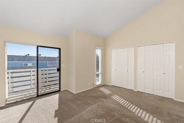 33611 Dana Vista Dr Unit 31, Dana Point, CA 92629 - unfurnished bedroom featuring multiple windows, multiple closets, access to outside, carpet, and high vaulted ceiling