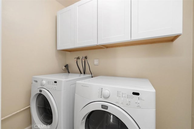 laundry area with washer and dryer and cabinet space