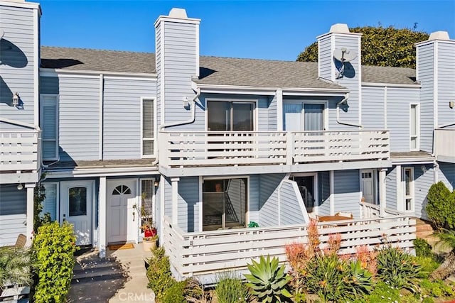 33611 Dana Vista Dr Unit 31, Dana Point, CA 92629 - rear view of house featuring a chimney, a balcony, and roof with shingles