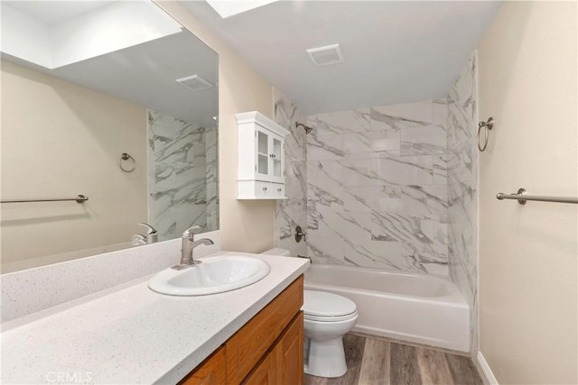 full bathroom with visible vents, toilet, shower / washtub combination, wood finished floors, and vanity