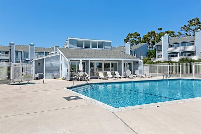 community pool featuring a patio area and fence