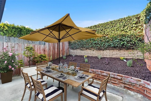 view of patio featuring outdoor dining area and a fenced backyard