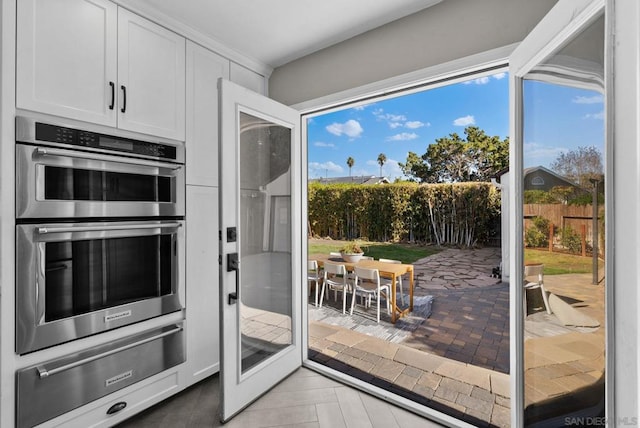 kitchen featuring white cabinets, double oven, and french doors