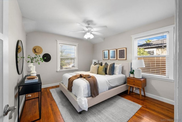 bedroom with dark wood-type flooring, ceiling fan, and vaulted ceiling