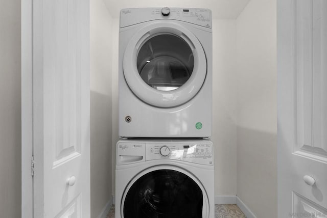 washroom featuring stacked washer and dryer