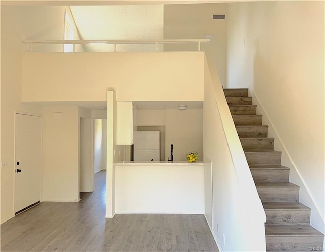 staircase with hardwood / wood-style floors