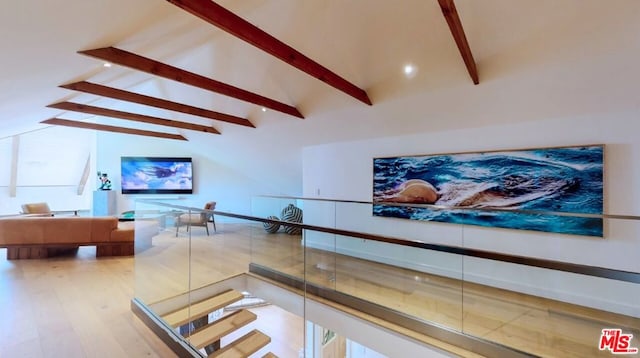 staircase with hardwood / wood-style flooring and lofted ceiling with beams