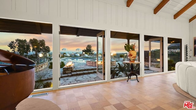 entryway featuring vaulted ceiling with beams