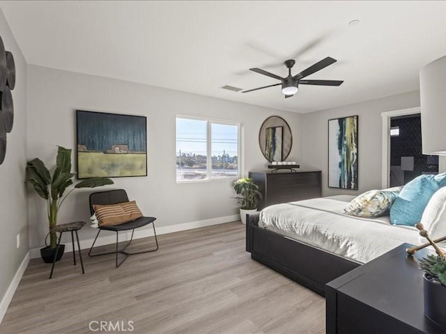 bedroom featuring ceiling fan and light hardwood / wood-style flooring