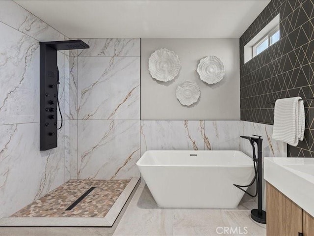 bathroom featuring independent shower and bath, tile walls, and vanity