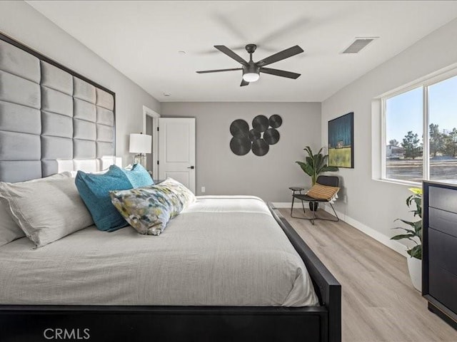 bedroom with light wood-type flooring and ceiling fan