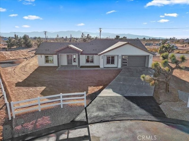 view of front of property with a garage and a mountain view