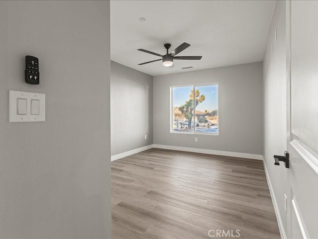 empty room featuring ceiling fan and light wood-type flooring