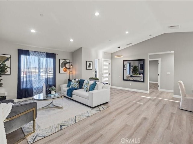 living room with vaulted ceiling and light hardwood / wood-style floors