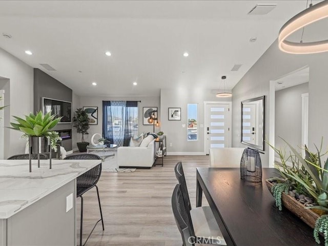 living room with lofted ceiling and light wood-type flooring