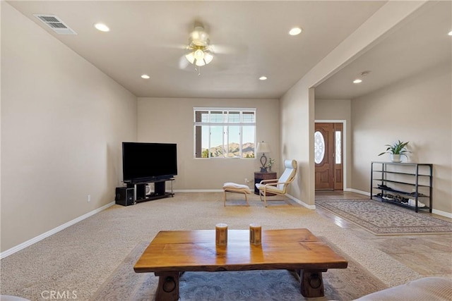 carpeted living room with ceiling fan