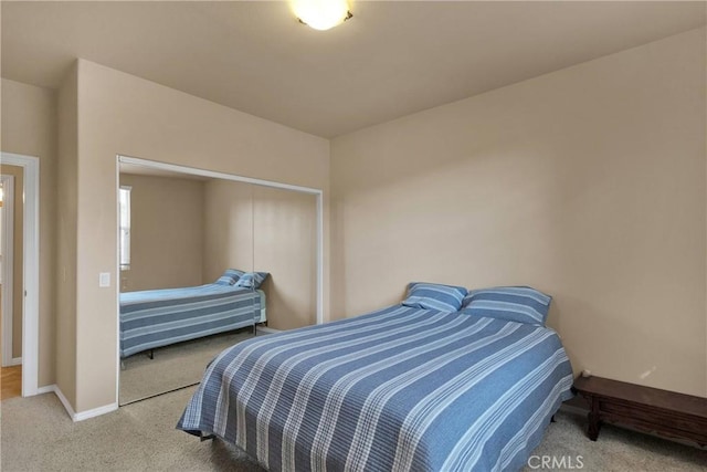 carpeted bedroom with a closet